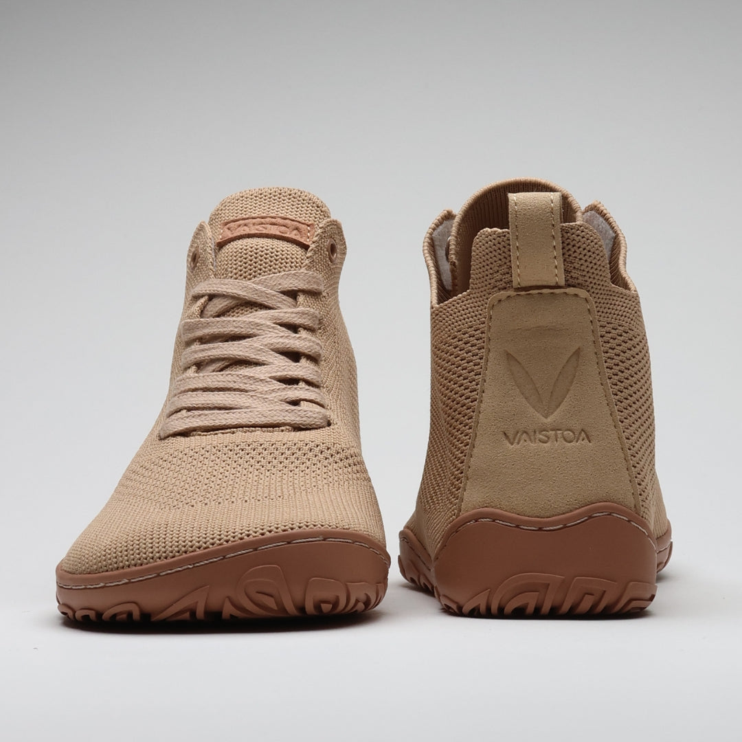 Vaistoa Iloa Mid latte-väriset korkeavartiset paljasjalkakengät kuvattuna edestä ja takaa – leveä jalanmuotoinen kärki, joustava tasapohja ja minimalistinen design tukevat luonnollista liikkumista.